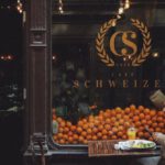 Consumer Behavior - Man in Brown Jacket Sitting on Chair in Front of Fruit Stand