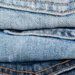 Market Trends - Stack of blue jeans arranged by color