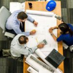 Crisis Management - Three People Sitting Beside Table