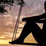 Thinking - Silhouette of Woman on Swing during Golden Hour