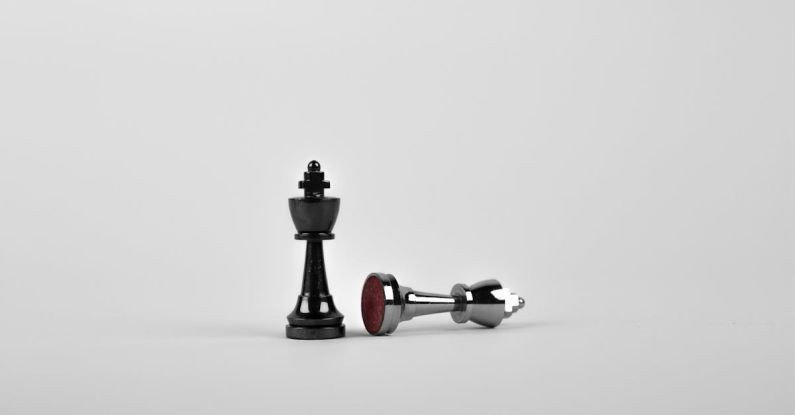 Strategy - Two Silver Chess Pieces on White Surface