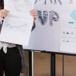 Social Entrepreneurship - Woman in Gray Coat Holding White Printer Paper