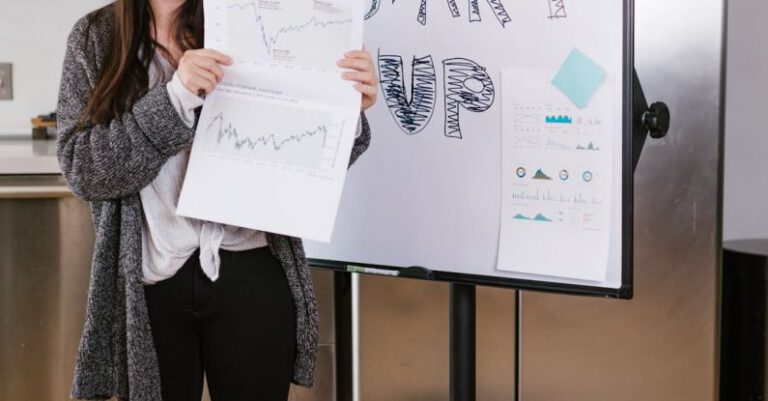 Social Entrepreneurship - Woman in Gray Coat Holding White Printer Paper