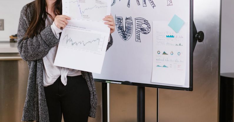 Social Entrepreneurship - Woman in Gray Coat Holding White Printer Paper