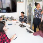 Collaboration - Women Colleagues gathered inside Conference Room