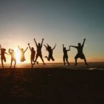 Teams - Silhouette Photography of Group of People Jumping during Golden Time