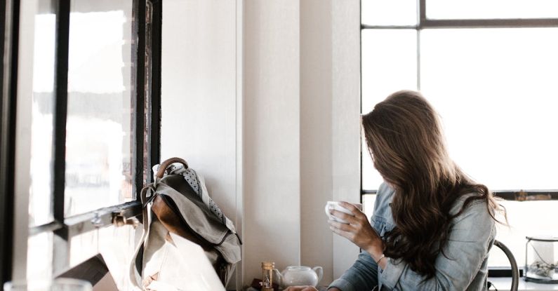 Workspaces - Woman in Gray Jacket Sitting Beside Desk